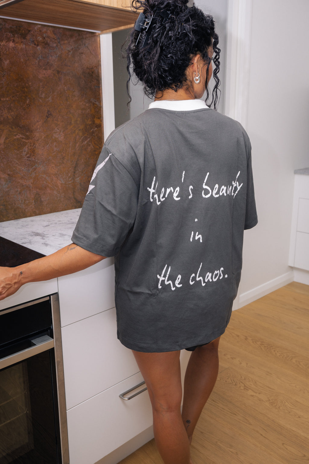 there's beauty in the chaos grey t-shirt in kitchen setting
