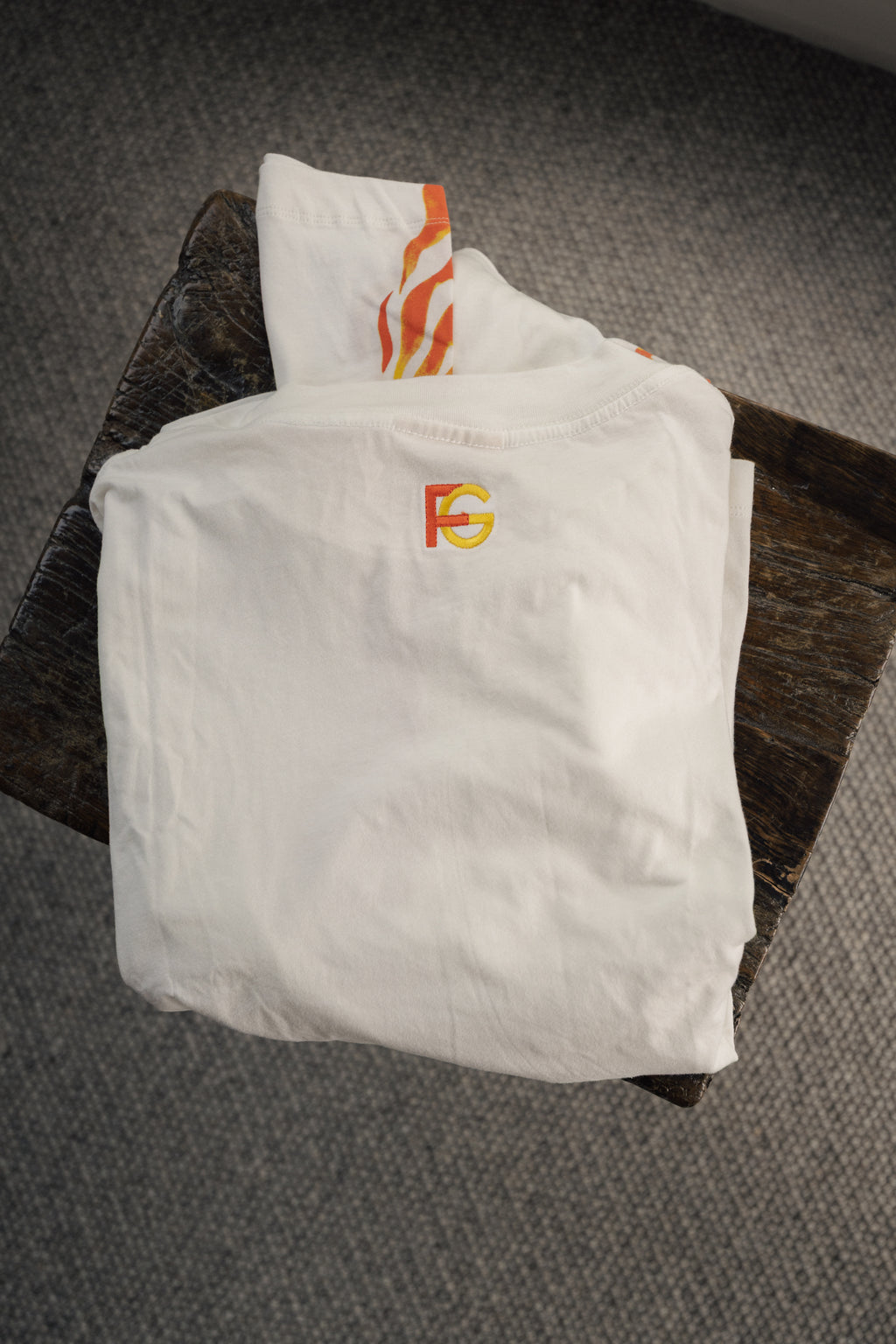 long sleeve white t-shirt with orange and yellow logo