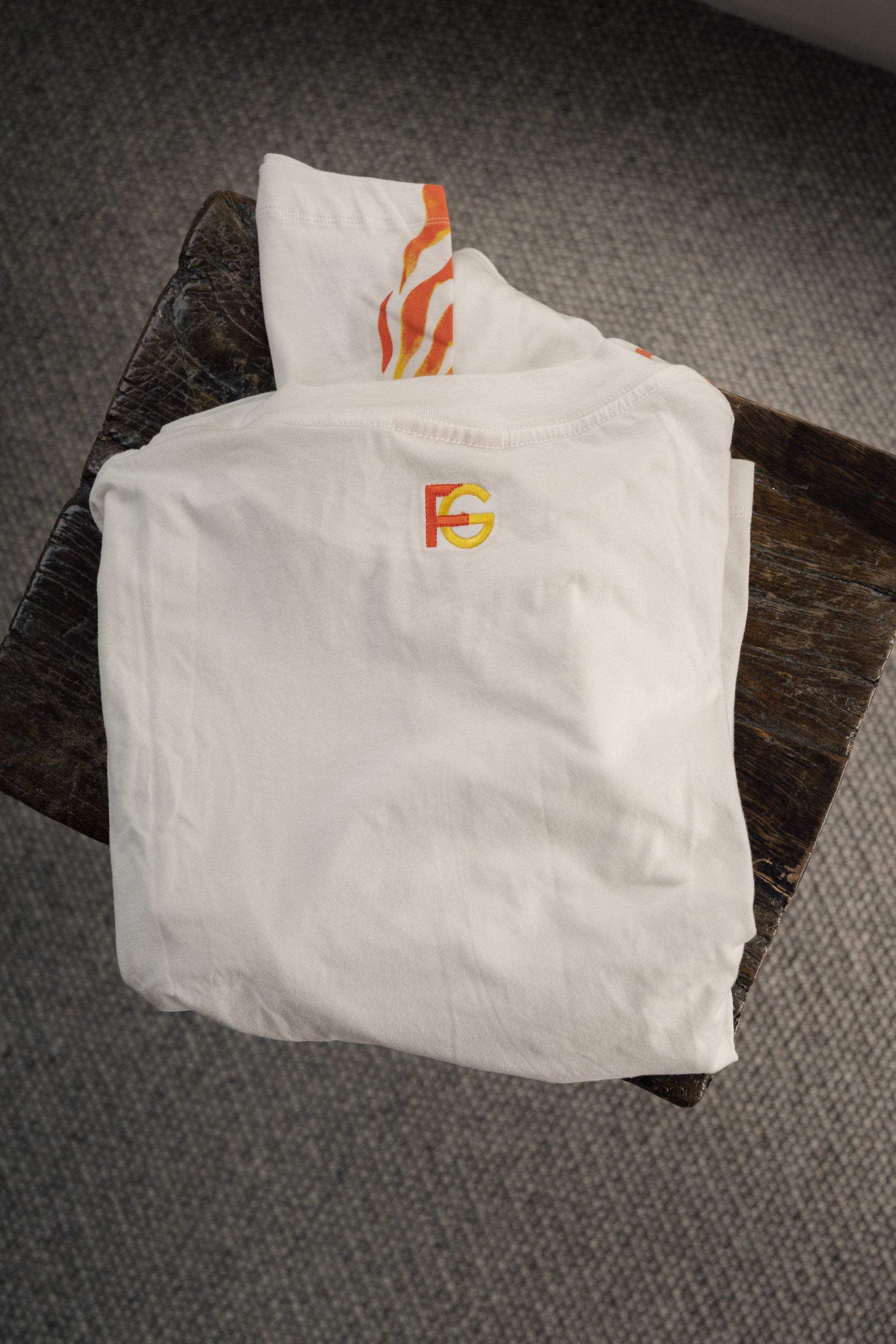 long sleeve white t-shirt with orange and yellow logo